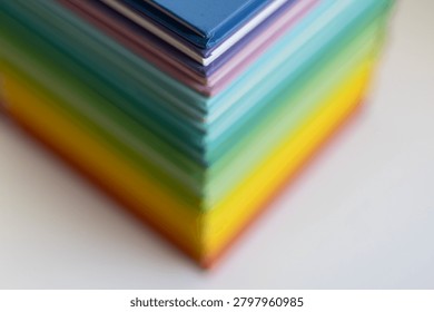 Macro corner view of a colorful stack of books with shallow depth of field