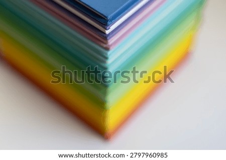 Macro corner view of a colorful stack of books with shallow depth of field