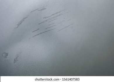 Macro Of Dent And Scratches On Silver Gray Car Surface. Car With Damage From Crash Accident, Parking Lot Or Traffic.