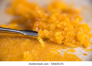 Macro detail of cannabis concentrate live resin (extracted from medical marijuana) with a dabbing tool 