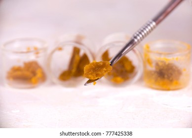 Macro detail of cannabis concentrate live resin (extracted from medical marijuana) isolated over white on a dabbing tool 