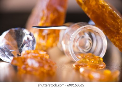Macro detail of Cannabis oil concentrate aka shatter with glass dabbing tools