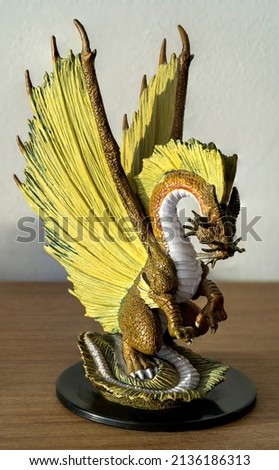 Macro detail of a golden dragon miniature
