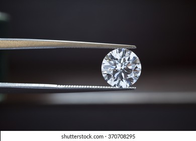 Macro diamond stone in tweezers