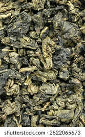 Macro dried tea leaf surface fullframe Tie Guan Yin background