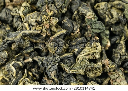 Macro dried tea leaf surface fullframe Tie Guan Yin background