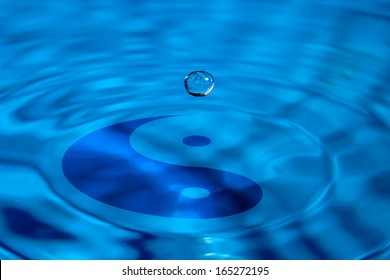 Macro droplet falls on the yin-yang symbol