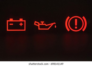 Macro Of Error Signs In Car. Red Icons Of Battery, Oil And Hand Break