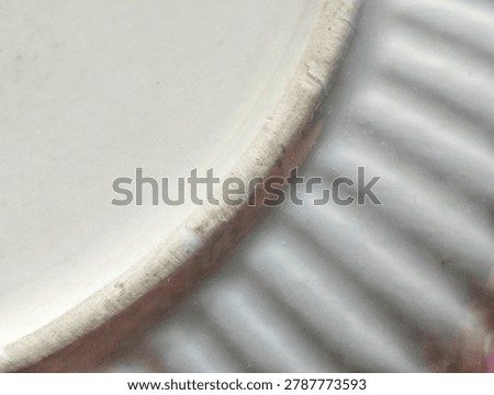 Macro extreme close-up of a rustic ceramic pottery piece, showing intricate ribbed texture and unglazed rim detail.