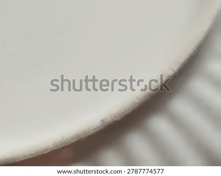 Macro extreme close-up of a rustic ceramic pottery piece, showing intricate ribbed texture and unglazed rim detail.