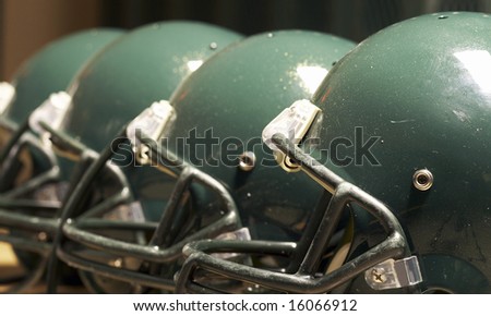 a macro of few football helmet on bench