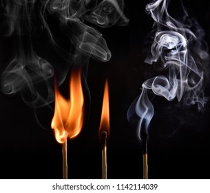 Macro fire burning on matchstick. Studio shot isolated on black background.
