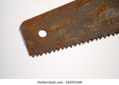 Macro focus on rusty blade or vintage handsaw isolated white background.