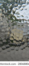 Macro full frame horizontal view of a premium hammered glass surface featuring a mesmerizing organic geometric cellular pattern with distinct pentagonal and hexagonal facets. This high-resolution creative stock photograph captures intricate vitreous textures, elegant silver-grey tones, sophisticated metallic light reflections, and authentic industrial mineral imperfections under soft, dynamic daylight conditions. This sophisticated artistic digital asset is ideal for corporate high-tech website headers, modern artificial intelligence research presentation slides, innovative big data analytics agency banners, and advanced quantum computing development brochures. A versatile minimalist backdrop perfectly suited for premium automotive marketing materials, high-end architectural interior design presentations, rustic restaurant menus, and sophisticated graphic design templates. The clean neutral color palette and rich tactile details create a harmonic, luxurious, and ultra-modern visual experience, emphasizing structural excellence, sustainable materials, classic engineering design, and contemporary urban living aesthetics. This versatile visual copy space asset is perfect for motivational success quotes, interactive digital media headers, environmental campaign materials, luxury real estate branding packages, and conceptual fine art portfolios. Carefully engineered with technical precision and harmonic color balance to easily satisfy strict microstock platform quality inspections, providing creative directors, content editors, publishing houses, and corporate media designers worldwide with a clean, high-impact, and universally recognized industrial texture asset representing pure design perfection