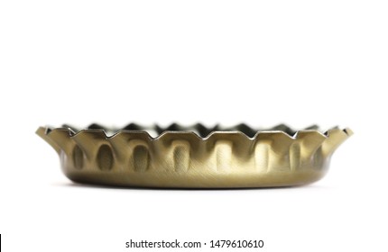 Macro golden bottle cap for beer isolated on white, side view 