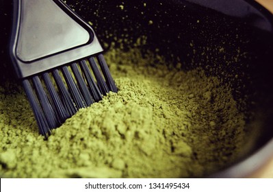 Macro Of Green Natural Henna Powder In A Bowl With  Black Brush. Organic Care And Eco Dye For Hair. Dried  Lawsonia Inermis As Colorant.