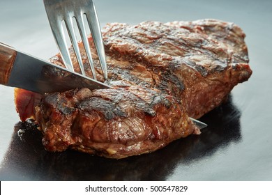 Macro of grilled meat on dark