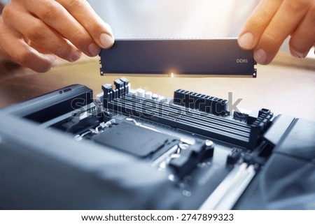 Macro of hands installing a DDR5 memory module. Perfect for hardware upgrades, IT services, and PC building guides