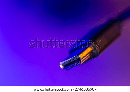 Macro hdmi connector in neon gradient. Video cable closeup.
