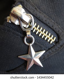 Macro Image Of Dangling Star Shaped Zipper Pull On Sneaker