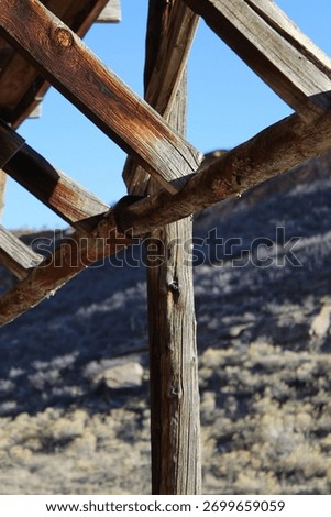 Macro image of an element of barn superstructure with western terrain in the background
