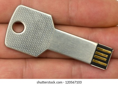 Macro Image Of A Hand Holding A Usb Key