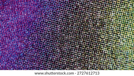 Macro image of a multicolor CMYK halftone gradient shifting from blue-magenta tones to yellow-green, created by densely packed dots on a textured printed surface.