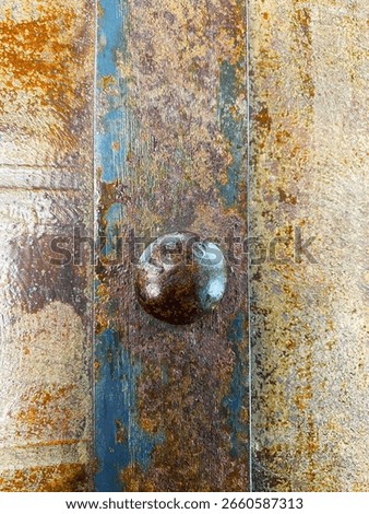 Macro image of rusty metal surface with an old bolt and weathered paint. Great for industrial backgrounds, grunge themes, or decay detail projects.