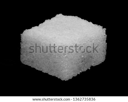Macro image of a sugar cube isolated on a black background