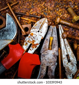Macro image of tools, nuts and screws on a rusty metallic background