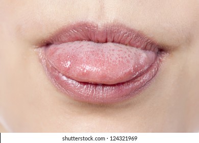 Macro image of a woman sticking her tongues out
