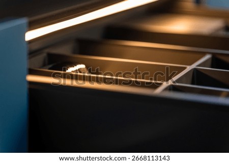 Macro kitchen drawer. Warm LED lighting. Premium detail focus