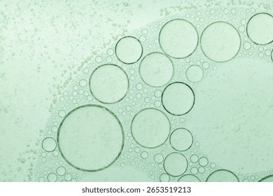 Macro microscope green bubble texture, Close-up Green bubbles and drops oil background . blue green water bubbles, close up golden oil drop for cosmetic