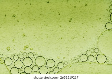 Macro microscope green bubble texture, Close-up Green bubbles and drops oil background . blue green water bubbles, close up golden oil drop for cosmetic