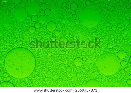 Macro microscope green bubble texture, Close-up Green bubbles and drops oil background . golden green water bubbles, close up golden oil drop for cosmetic