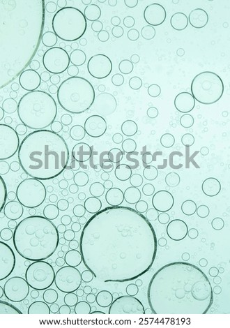 Macro microscope green bubble texture, Close-up Green bubbles and drops oil background . blue green water bubbles, close up golden oil drop for cosmetic	