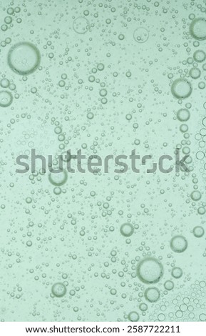 Macro microscope green bubble texture, Close-up Green bubbles and drops oil background . blue green water bubbles, close up golden oil drop for cosmetic	