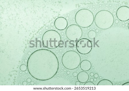 Macro microscope green bubble texture, Close-up Green bubbles and drops oil background . blue green water bubbles, close up golden oil drop for cosmetic