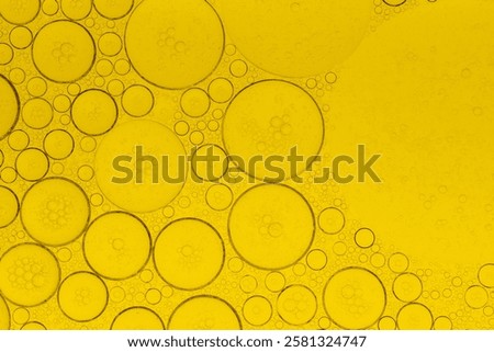 Macro microscope yellow bubble texture, Close-up Yellow bubbles and drops oil background . golden Yellow water bubbles, close up golden oil drop for celebration	