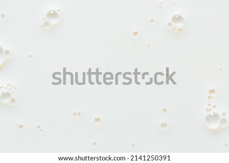 Macro milk texture,White surface of milk and bubbles and ripples from above birds eye view 