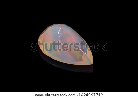 macro mineral stone faceted opal on a black background close-up