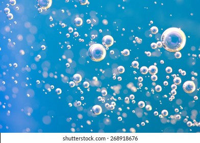 Macro Oxygen bubbles in water on a blue background, concept such as ecology and other your successful projects - Shutterstock ID 268918676
