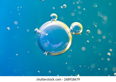 Macro Oxygen Bubbles In Water On A Blue Background, Concept Such As Ecology And Other Your Successful Projects