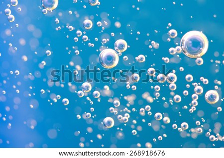 Macro Oxygen bubbles in water on a blue background, concept such as ecology and other your successful projects