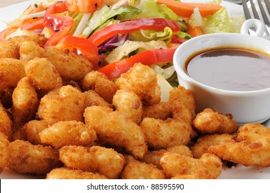 Macro Of A Pate Of Breaded Popcorn Shrimp And A Chinese Salad