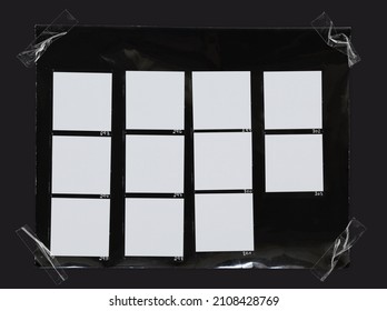 macro photo of black and white hand copy contact sheet with 11 empty film frames fixed by transparent sticker tape on dark background.