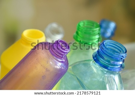 Macro photo of bottlenecks. Collecting plastic containers for recycling, upcycling, downcycling. Closeup of multicolored plastic bottles on blurred background. Environment conservation. Reducing waste