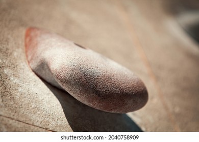 Macro Photo Of Climbing Holds On Worn Wall Outside. Artificial Rock Climbing Wall At Park. Bouldering Parkour Detail.