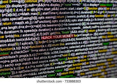 Macro photo of computer screen with program source code and highlighted HIJACK YOUR MONEY inscription in the middle. Script on the screen with virus in it. Cyber security concept. Technology