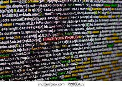 Macro photo of computer screen with program source code and highlighted HIJACK YOUR PHOTOS inscription in the middle. Script on the screen with virus in it. Cyber security concept. Technology